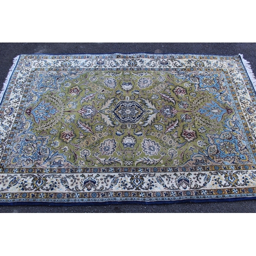 15 - Indo Persian rug with a medallion and all-over stylised floral design on a pale green ground with bo... 