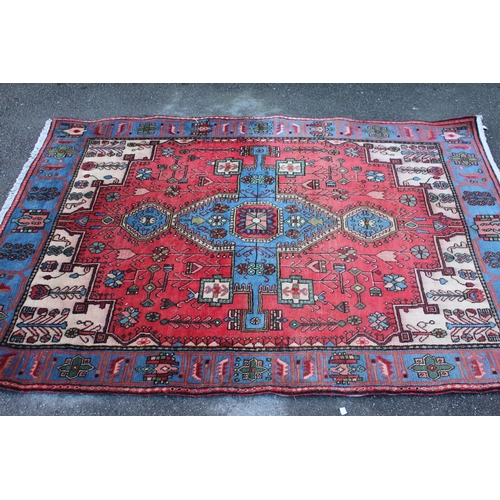 18 - Turkish rug with a lobed medallion and all-over stylised floral design on a red ground with blue med... 