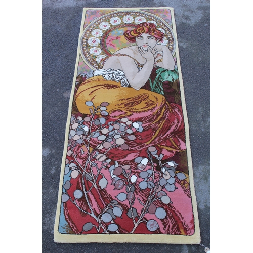 20 - Modern woolen rug woven with a pictorial design after Alphonse Mucha, 98ins x 40ins approximately