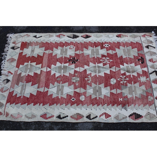 31 - Small Kelim rug, Turkoman tent bag and two cushion covers