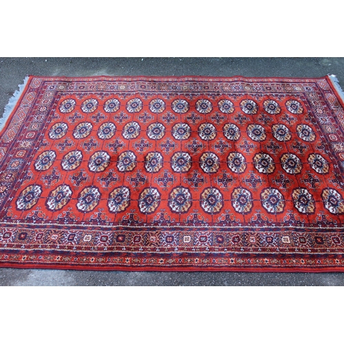 34 - Machine woven rug of Turkoman design, 7ft 4ins x 5ft 8ins approximately, together with a similar sma... 