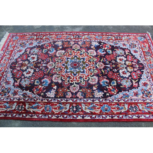 35 - Tabriz rug with a medallion and all-over floral design on a dark ground with borders, 8ft x 4ft 10in... 