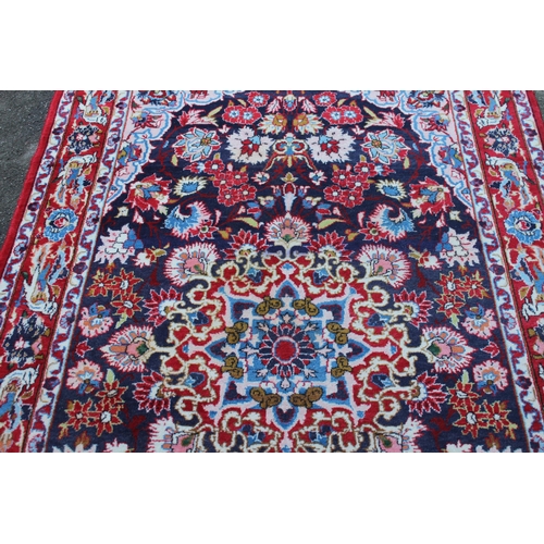 35 - Tabriz rug with a medallion and all-over floral design on a dark ground with borders, 8ft x 4ft 10in... 
