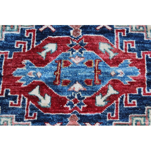 37 - Afghan Ziegler type carpet with a medallion and all over stylised design in shades of red, green and... 