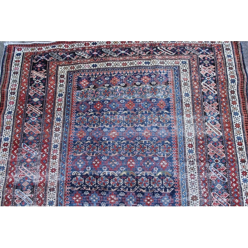 39 - Shirvan rug with blue ground repeating rosette centre panel and multiple borders (various areas of w... 