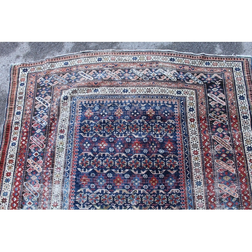 39 - Shirvan rug with blue ground repeating rosette centre panel and multiple borders (various areas of w... 
