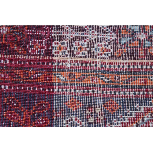 40 - Qashqai rug with central medallion design on red and blue ground with borders, 96ins x 64ins