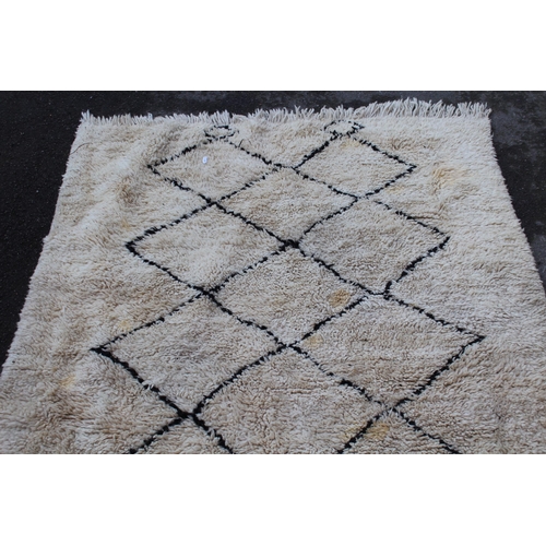 42A - Berber carpet with dark lattice design on cream ground, 7ft x 4ft 10ins approximately