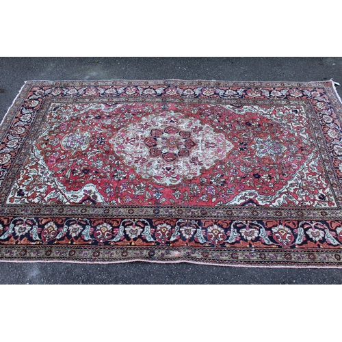 7 - Tabriz rug with a lobed medallion and all-over floral design on a rose ground with multiple borders,... 
