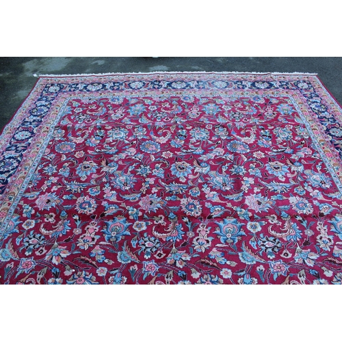 9 - Tabriz carpet with an all over palmette design on a claret ground with polychrome borders, 12ft x 9f... 