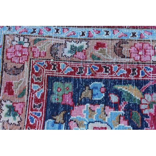 9 - Tabriz carpet with an all over palmette design on a claret ground with polychrome borders, 12ft x 9f... 