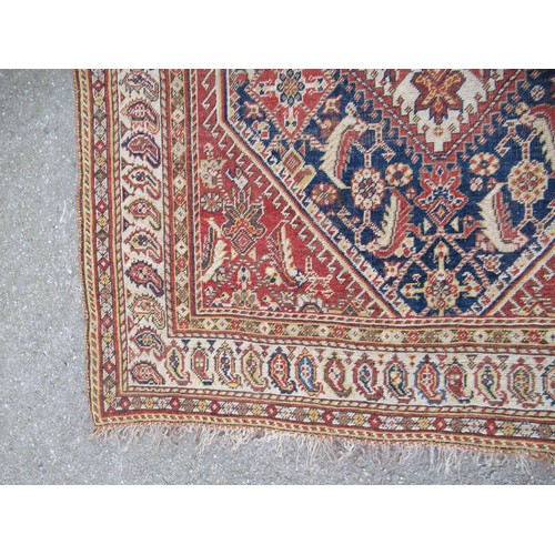 28 - Small Qashqai rug with a triple repeating medallion design on a midnight blue ground with corner des... 