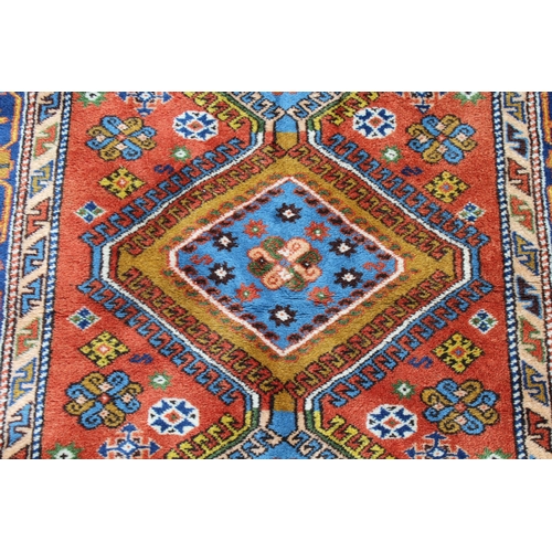 20 - Turkish Caucasian design rug having three central hooked medallions with multiple borders on a rust ... 