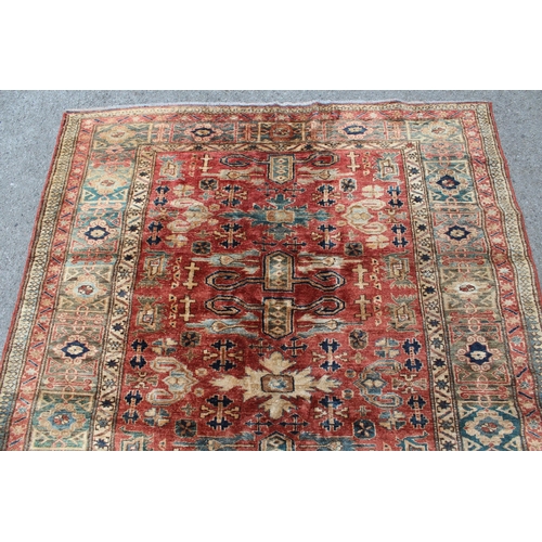 5 - Modern Afghan rug of Caucasian design with a rams horn and all-over stylised design on a rust ground... 