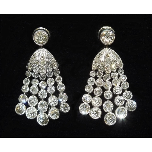 322 - A pair of diamond tassel earrings, each with a millegrain-set old-cut diamond above a rose-cut diamo... 