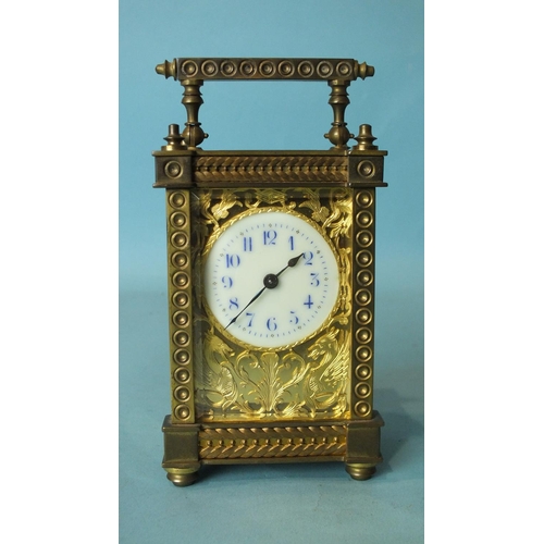 137 - A late-19th/early-20th century brass carriage timepiece with ornate gorge case, the face with cut br... 