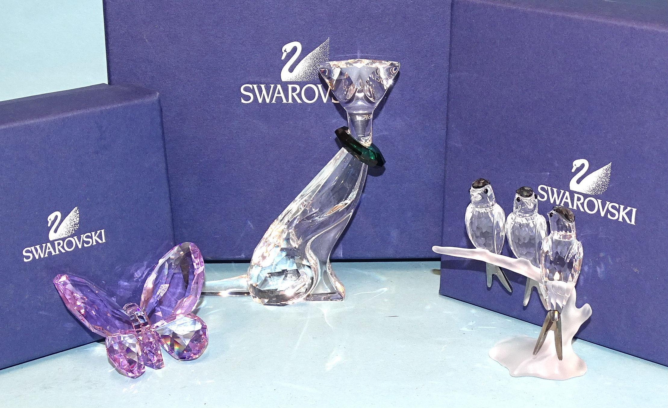 A Swarovski glass group of three swallow...