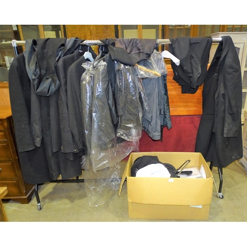 21 - A collection of mourning clothing including dark suits, overcoats, etc, various sizes, formerly used... 