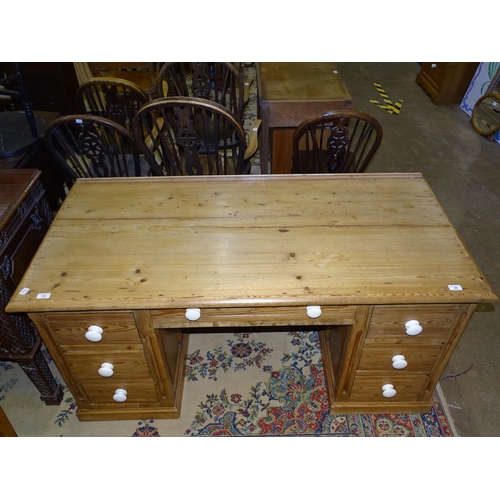 25 - A mainly pitch pine panel knee-hole desk, having a central drawer and six pedestal drawers, 150... 