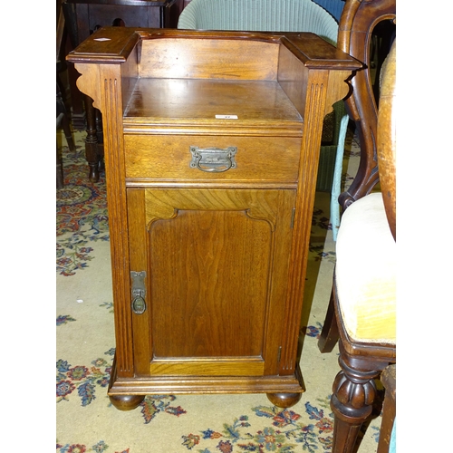 27 - An Edwardian walnut bedside cupboard fitted with a single drawer above a cupboard door, 48cm wide, 7... 