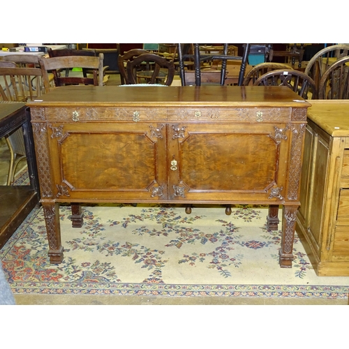 32 - A mahogany low sideboard in the Chippendale taste, decorated with fretwork and foliate carving, on s... 