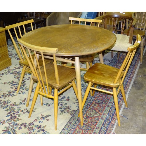 5 - An Ercol circular dining table, 89cm diameter and four chairs.