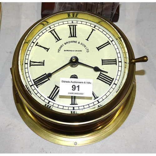 A Sestrel brass bulkhead ships clock, the dial marked Henry Barnebys