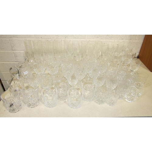 66 - A large collection of cut-glass wine glasses, highball and other glasses, two art glass jugs and oth... 