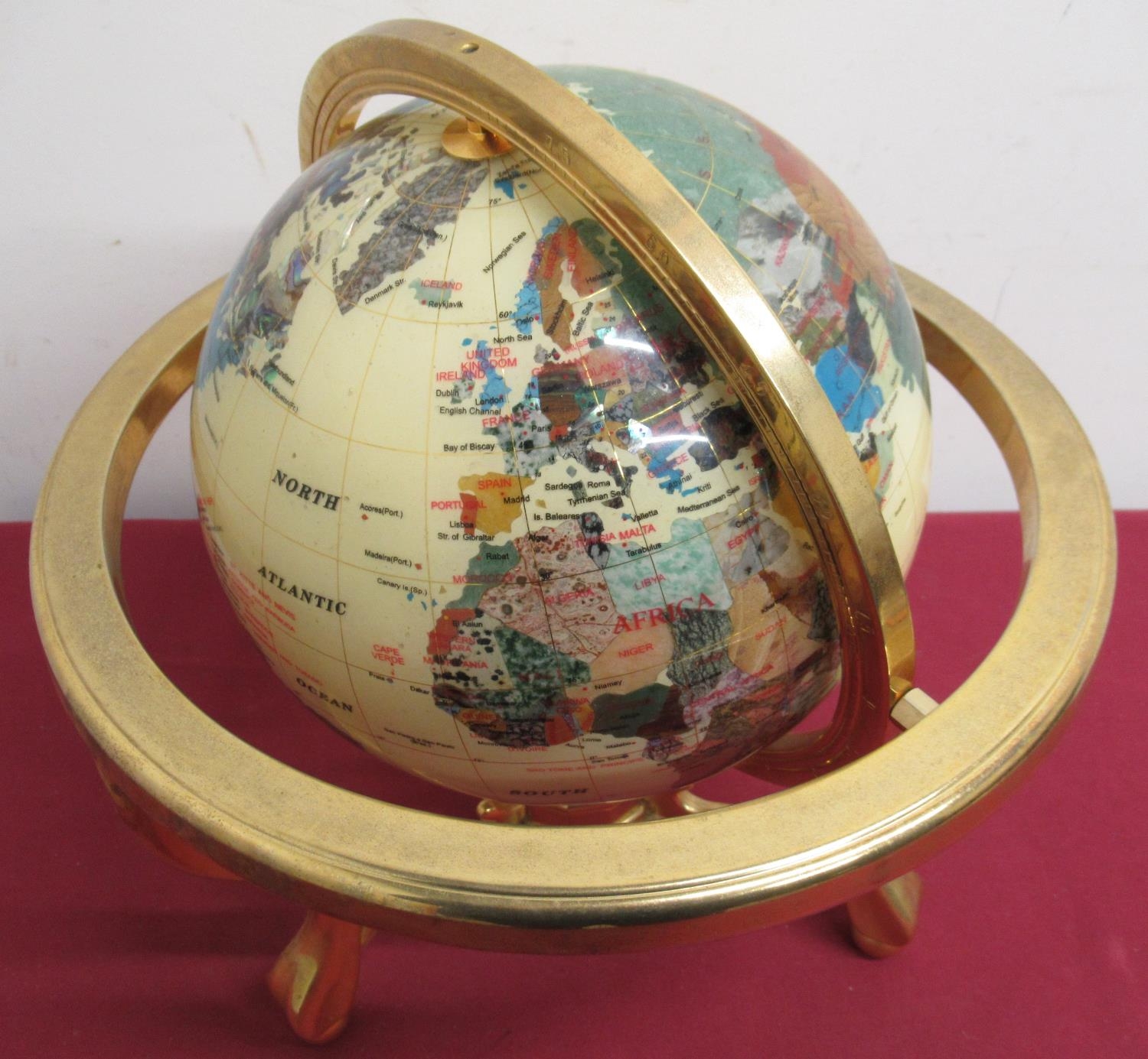 Polished crystal style terrestrial globe, on brass stand with compass