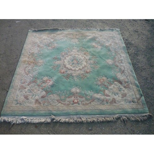 1327 - Chinese embossed woollen rug, green ground central floral medallion and floral pattern border L250cm... 