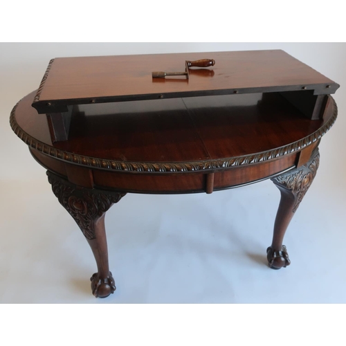 1318 - Geo.III style mahogany extending dining table, with gadroon carved oval top on C scroll carved legs ... 