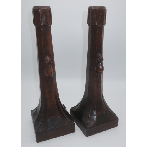 1002 - Robert Mouseman Thompson - a pair of early oak candlesticks of good colour, with triangular carved s... 