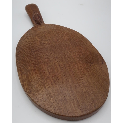 1023 - Robert Mouseman Thompson - an adzed oak oval cheeseboard, handle carved with signature mouse  L37cm