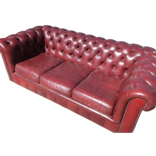 1320 - Chesterfield sofa, upholstered in deep buttoned Oxblood leather, three loose seat cushions W190cm D9... 