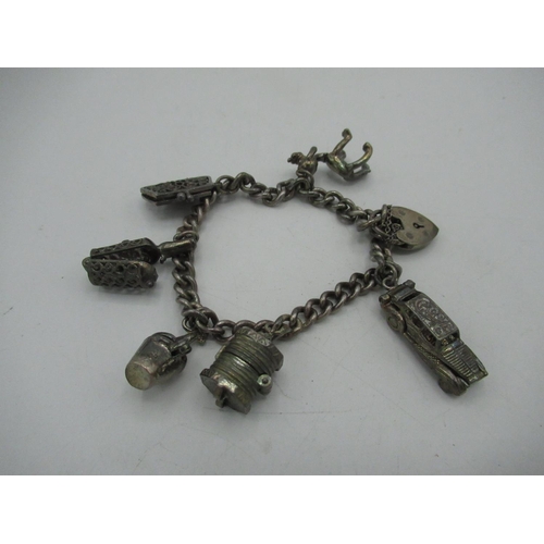 26 - Sterling silver charm bracelet including purse, ship in a bottle, car etc stamped 925 1.5ozt