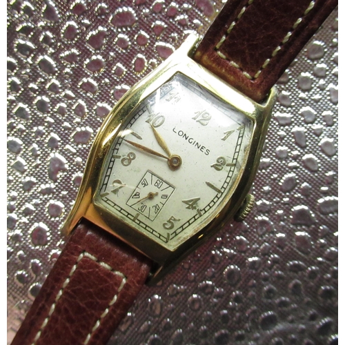 114 - 1940's Longines hand wound wristwatch. 10K gold filled tonneau case on later Longines leather strap.... 