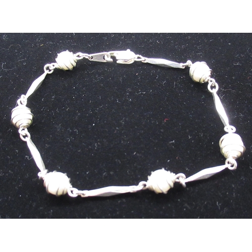 35 - 18ct white gold plated bracelet with pearls enclosed by spirals linked by geometric shapes with lobs... 