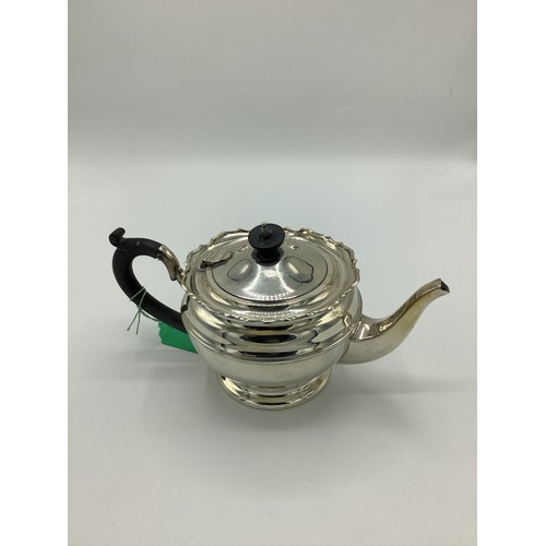 6 - Geo.V silver teapot, ebony handle and finial on circular stepped foot, Birmingham 1924, H13cm.
