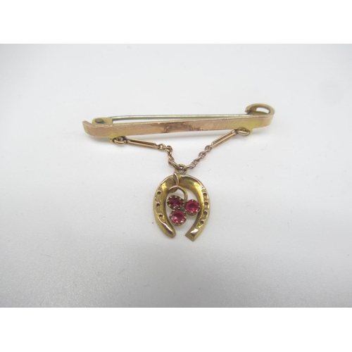 651 - Victorian 9ct rose gold bar brooch with three garnets mounted in horseshoe pendant suspended on a ch... 