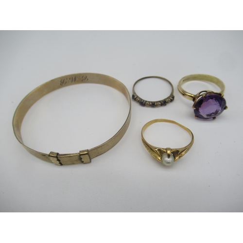 655 - Child's 9ct gold bangle, a 9ct gold solitaire ring with claw set purple stone and two other unmarked... 