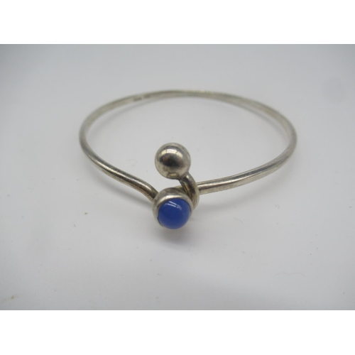 656 - Hallmarked sterling silver bangle with blue stone mounted on hook clasp, Birmingham, 1983, a hallmar... 