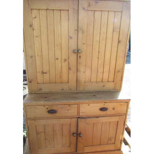 708 - Pine side cabinet, twin planked doors above two drawers and two similar doors on a plinth base, W125... 