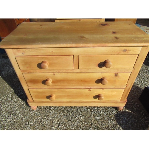 710 - Pine chest of two short and two long drawers with turned wooden handles and feet