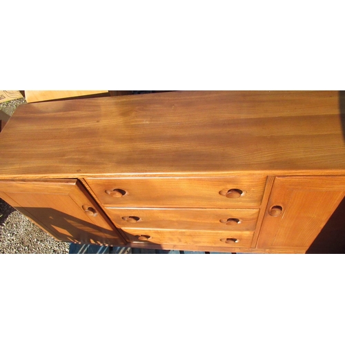 712 - Ercol light elm rectangular sideboard with two cupboards enclosing three drawers W115cm D43cm H68cm