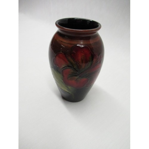 648 - Moorcroft ovoid vase decorated in Hibiscus pattern on a red shaded ground, impressed marks and blue ... 