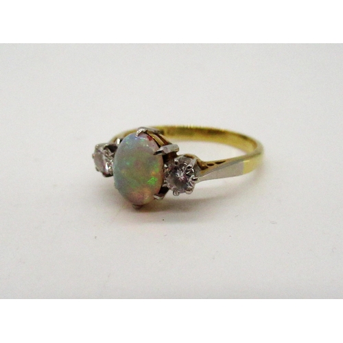 76 - 18ct yellow gold opal ring flanked by two diamonds set in a platinum mount, stamped 18ct PLAT, Size ... 