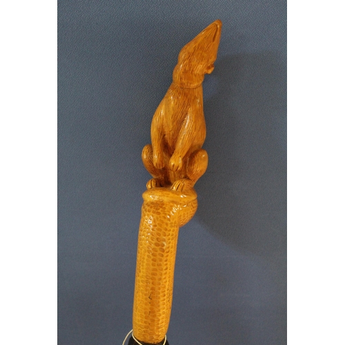 369 - David Hames - a walking stick with twist carved shaft and rodent carved handle, signed on metal ferr... 