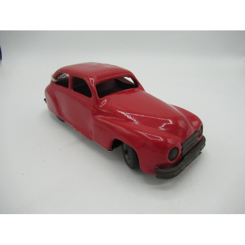 193 - Chad Valley red tinplate clockwork saloon car with rubber tyres, L19cm