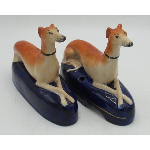 1252 - Pair of Victorian Staffordshire Greyhound pen stands, with crossed paws on gilt lined blue bases, W1... 