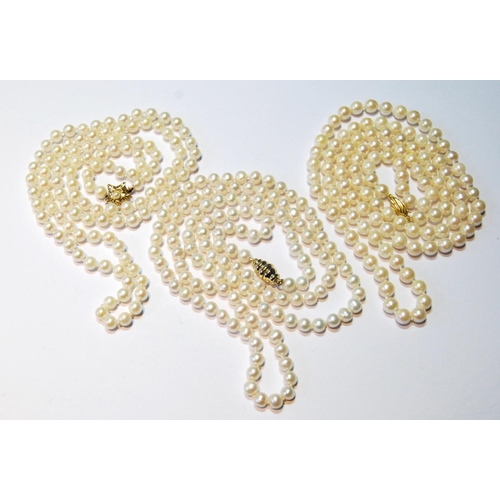 85 - Three opera length pearl necklaces, two with gold snaps.